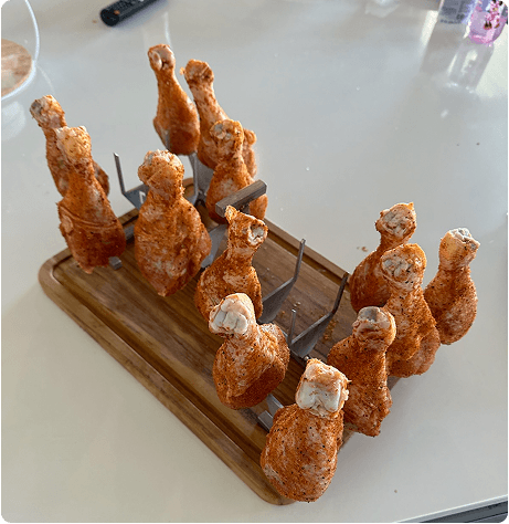 Raw chicken wings placed on WingRack stainless-steel pins
